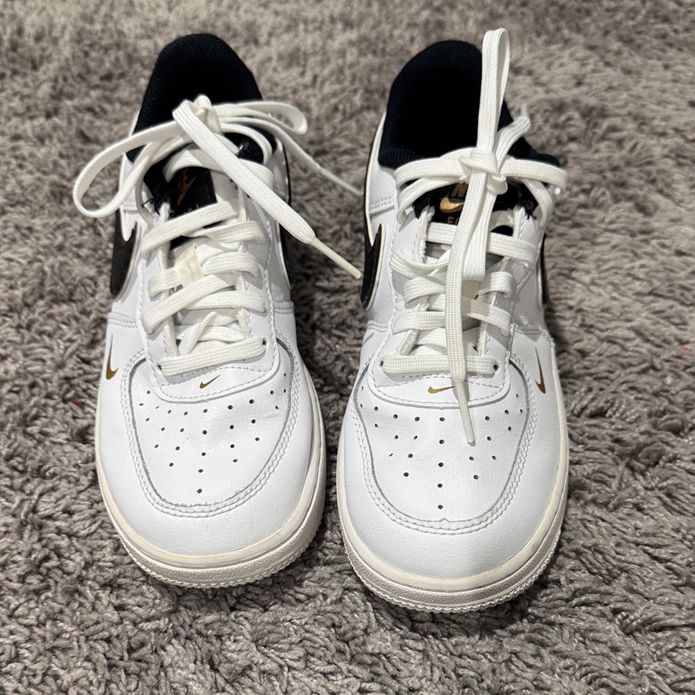 Nike Kids White and Black Sneakers with Gold Accents